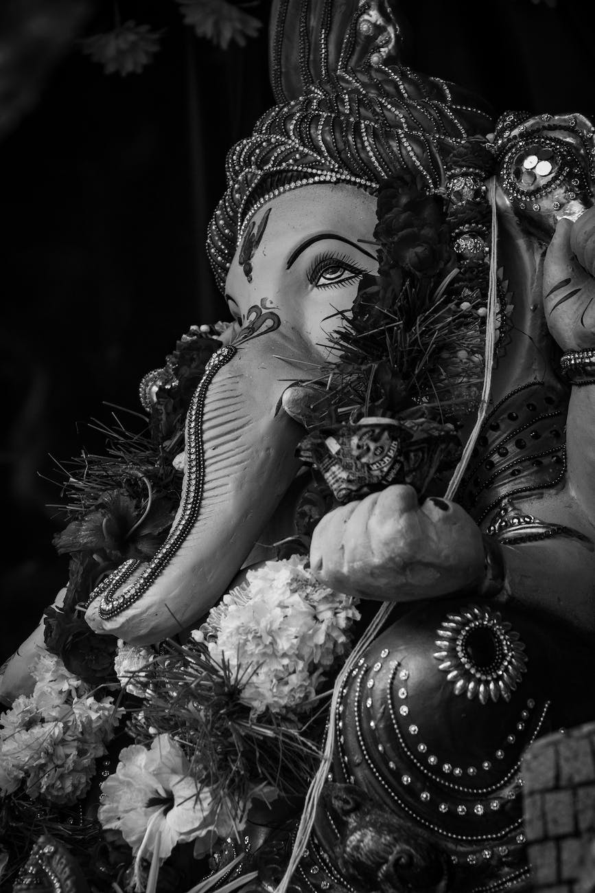 grayscale photo of ganesha decorated with flowers